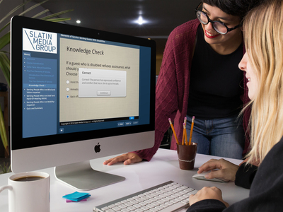 Two employees taking the Elements of Service E-Learning Course online
